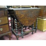 A 1930's Oak Drop Leaf Gate Leg Table, oval top, on barley twist stretched legs.