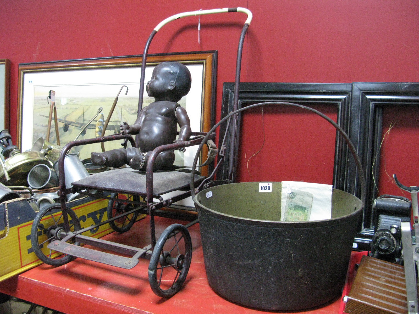 An Early XX Century Dolls Pram, pottery black baby doll, Victorian Brass Jam Pan, a Page £1