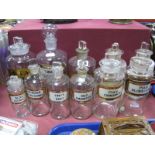 Eleven Early XX Century and Later Chemists Glass Jars, each with stoppers, and labels:- One Tray