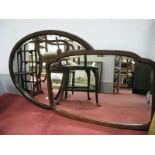 An Early XX Century Oval Bevelled Wall Mirror, in mahogany frame, another in shaped frame. (2)