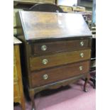 An Edwardian Inlaid Mahogany Bureau, with fall front, fitted interior, over three drawers on