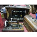 A Winselmann 'Titan' Sewing Machine, (poor walnut case); and a cased electric Singer sewing