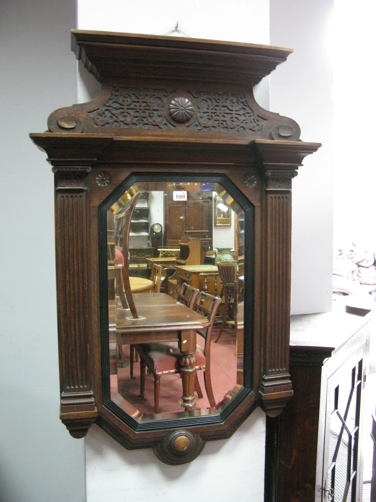 An XIX Century Oak Wall mirror, with a stepped gallery reeded sides, with a octagonal bevelled