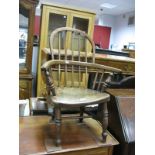 A XIX Century Child's Elm Windsor Chair, with spindle back turned legs, united by 'H' stretcher.