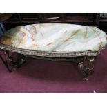 A XX Century Rectangular Shaped Coffee Table, with onyx top, supported by four gilded brass figures,