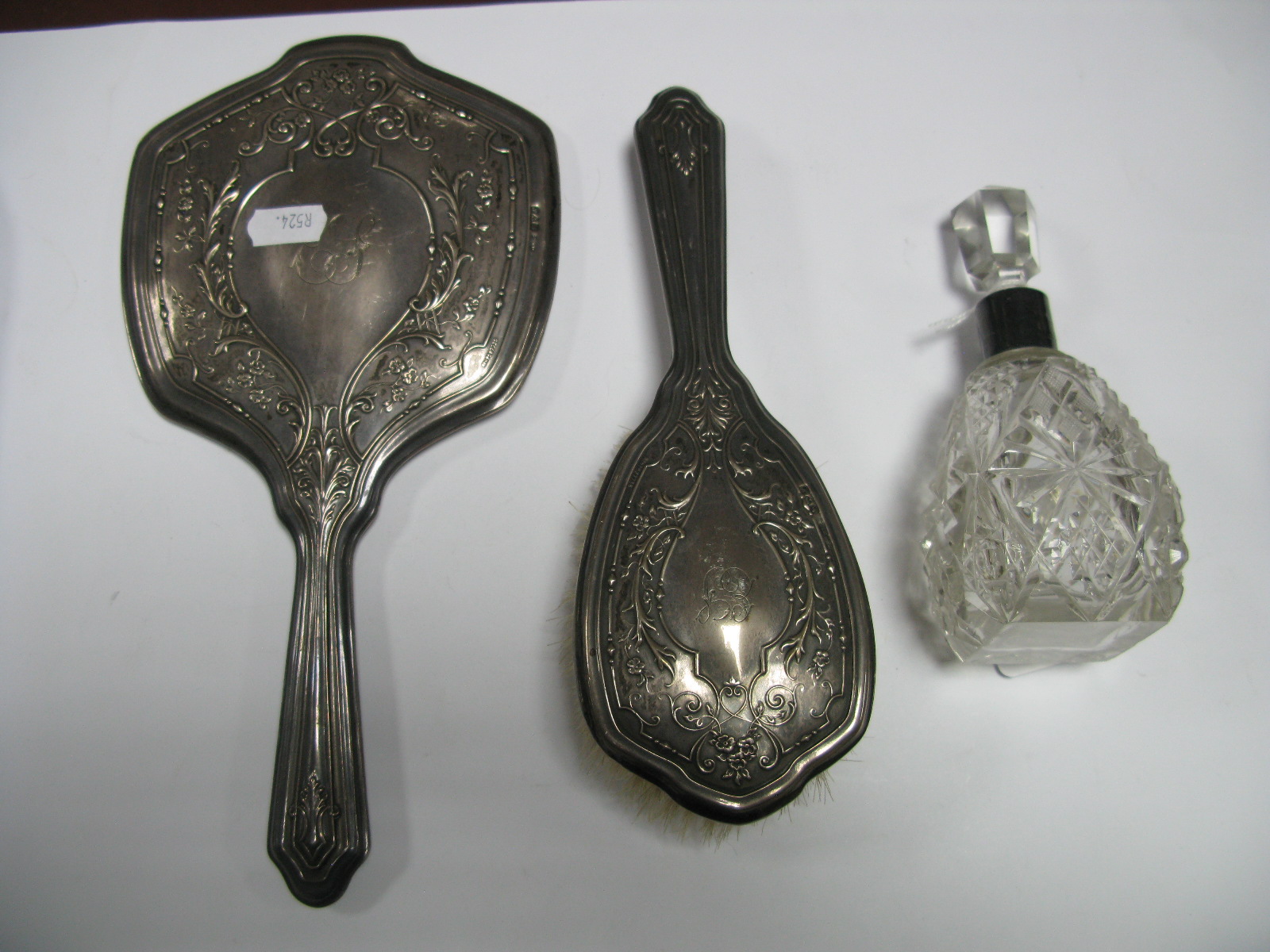 A Chester Hallmarked Silver Backed Hand Mirror and Hair Brush; together with a hallmarked silver