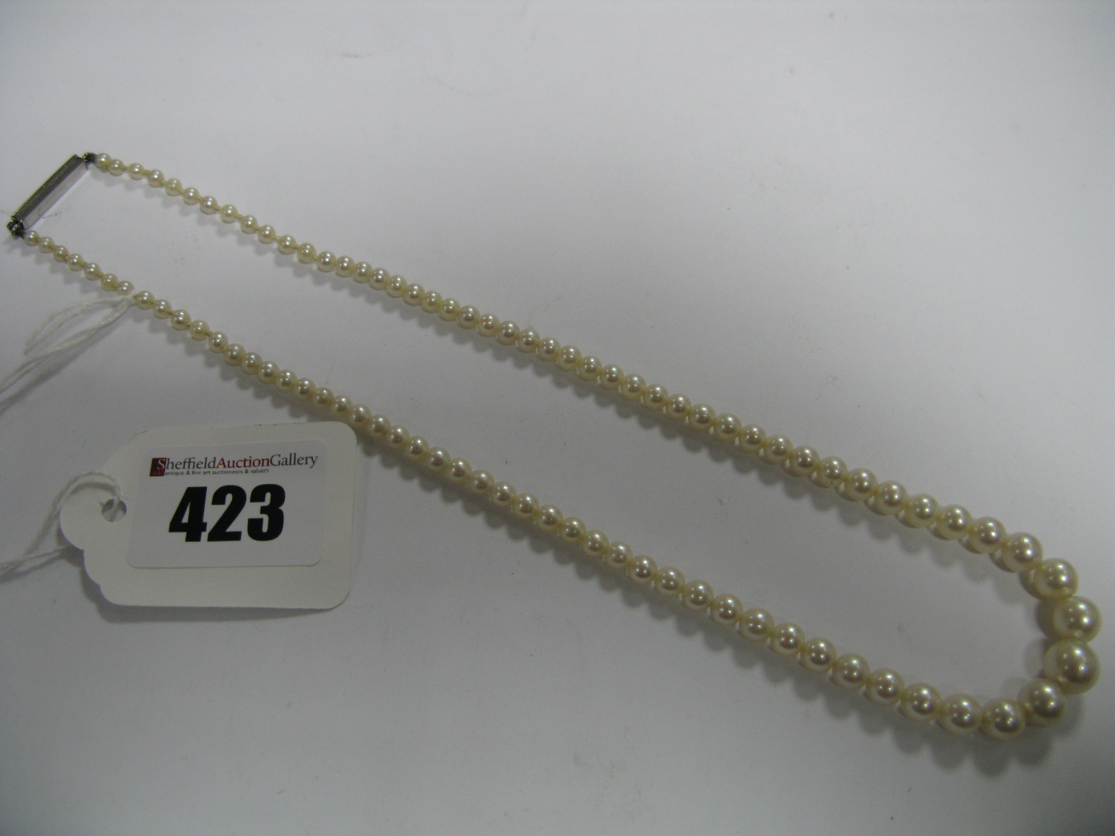 A Single Strand Graduated Pearl Bead Necklace, part knotted to single cut diamond set line clasp.