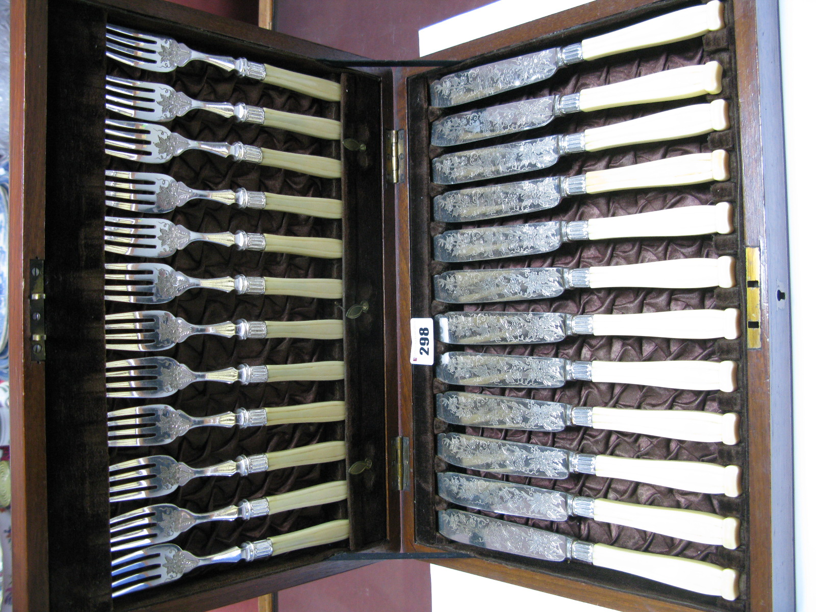 Early XX Century Fish Knives and Forks with decorative blades in mahogany case.