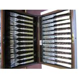 Early XX Century Fish Knives and Forks with decorative blades in mahogany case.