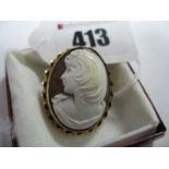 A 9ct Gold Cameo Style Brooch, depicting female form, collet set, within ropetwist border.