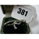 A Delicate Three Stone Diamond Ring, the graduated brilliant cut stone claw set, between knife