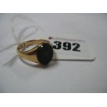 An Oval Hardstone Inset Panel Signet Ring, between plain setting and shoulders, stamped "18".