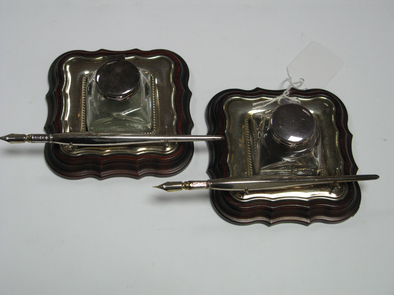 A Pair of Modern Hallmarked Silver Mounted Glass Inkwells on Stands, each base of shaped square