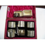 A Matched Set of Five Hallmarked Silver Napkin Rings, together with another, each of plain design,