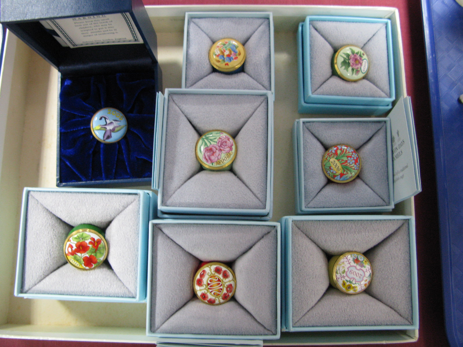 Eight Halcyon Days Circular Enamel 'Year' Trinket Pots, 2003, 2004, 2005, 2006, 2008, 2009, 2010 and