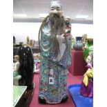 A Late XIX Century Chinese Gentleman Figure Holding a Child, enamel decoration to the kimono,