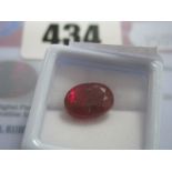 An Oval Cut Ruby, unmounted, with a Global Gems Lab Certificate card stating carat weight 7.95 (