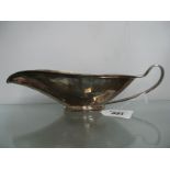A Modernist Style Sauce / Gravy Boat, of stylised elongated form, with loop handle, on oval rim