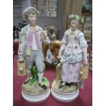 A Pair of XX Century Continental Figures, in classical dress, both carrying watering cans 30cm high