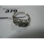 A Modern Diamond Set Cluster Style Dress Ring, claw set throughout, stamped "18KT .50".