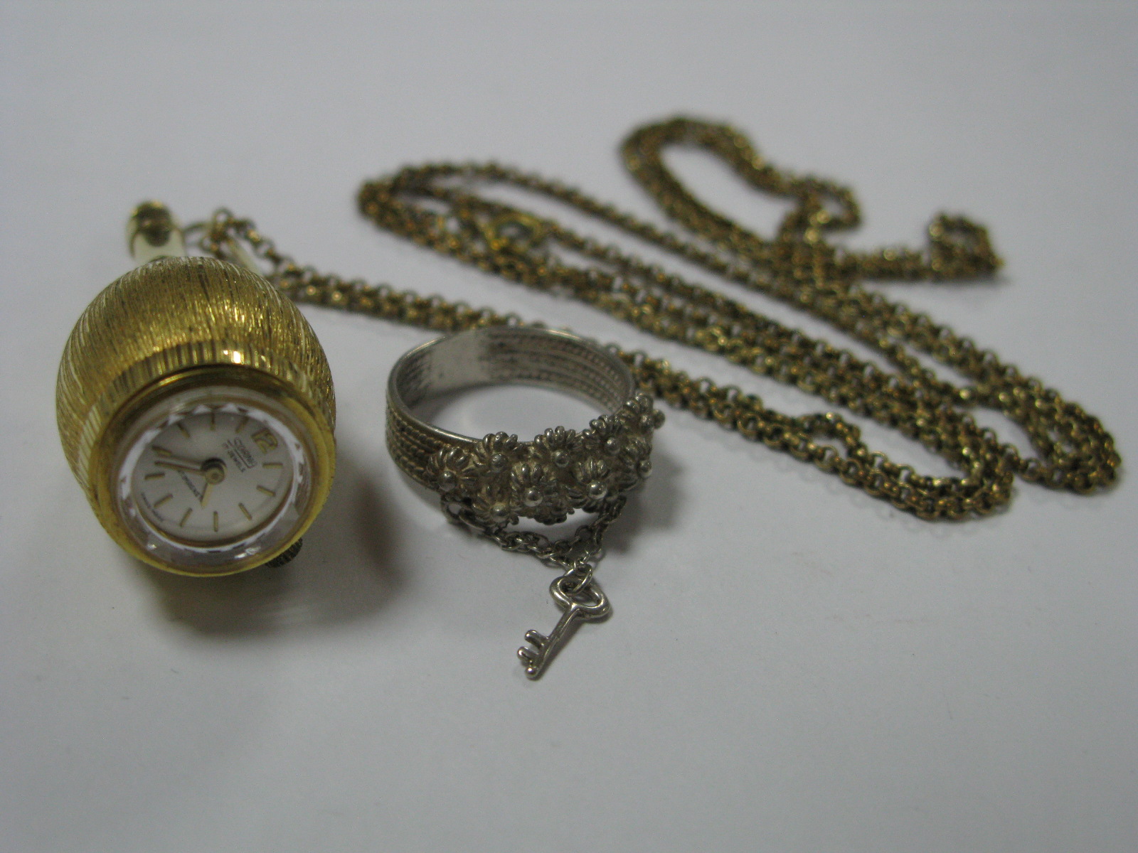 Sorna; A Novelty Bottle Shape Watch Pendant, on belcher link chain; together with a decorative