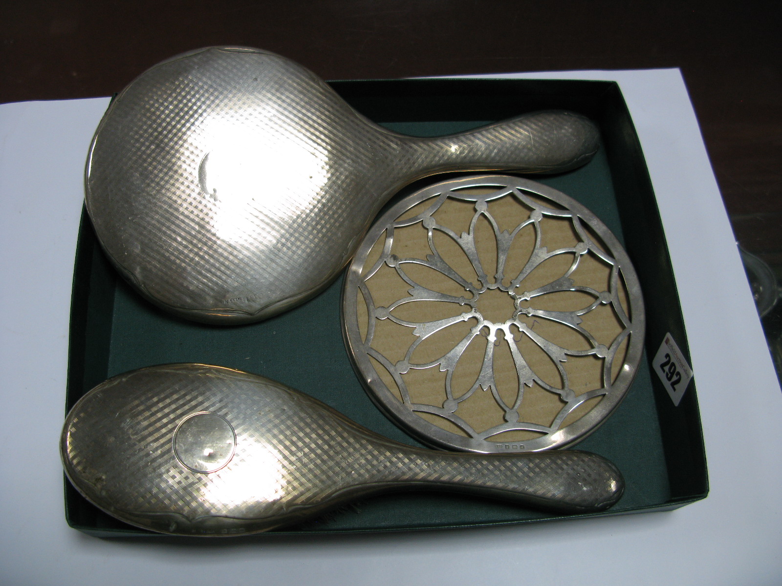 A Silver Backed Hand Mirror and Matching Brush, Birmingham hallmark, together with a silver