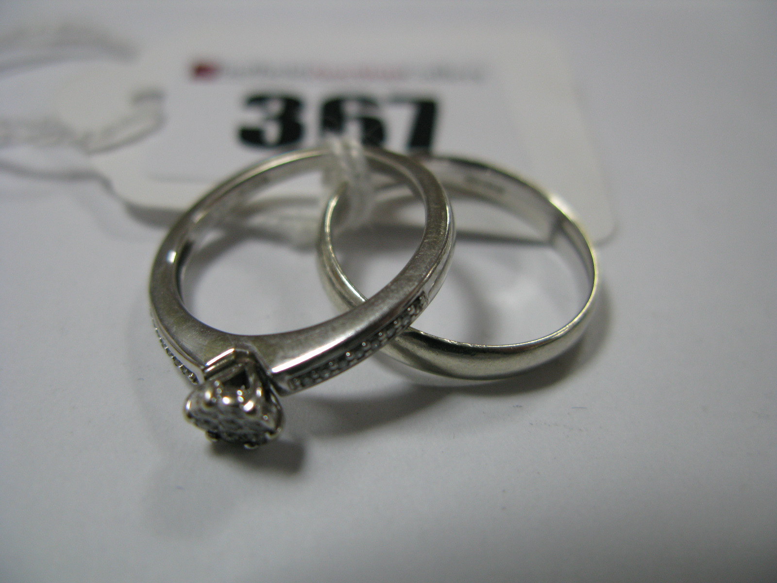 A Modern 9ct White Gold Diamond Cluster Ring, illusion set between inset shoulders, stamped "0.