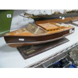 A Wooden Model of a Speedboat, on a plinth.