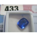 A Cushion Cut Sapphire, unmounted, with a Global Gems Lab Certificate card stating carat weight 7.35