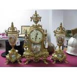 A XIX Century French Style Clock. garniture set in gilded brass, circular dial with floral