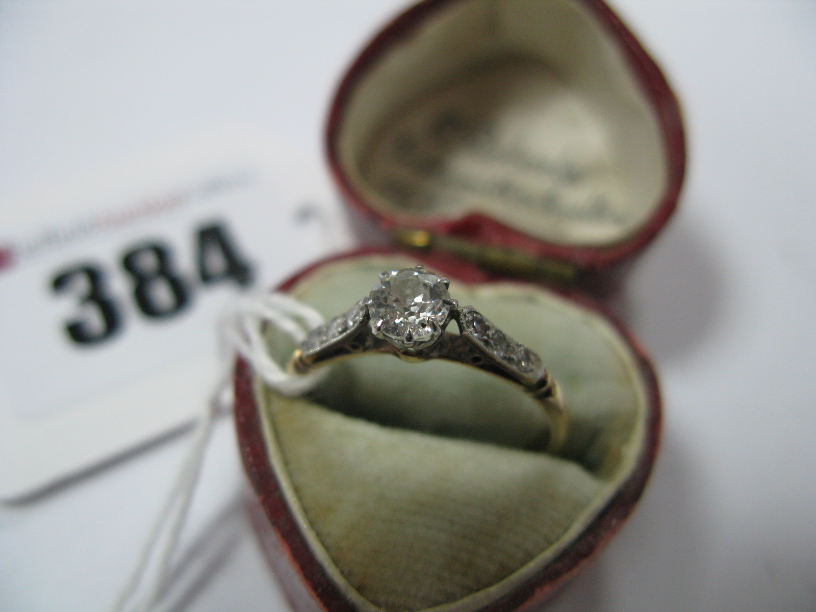 A Single Stone Diamond Ring, the old cut stone claw set, between inset shoulders, stamped ''18ct