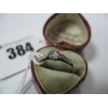 A Single Stone Diamond Ring, the old cut stone claw set, between inset shoulders, stamped ''18ct