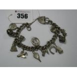 A Hallmarked Silver Curb Link Bracelet, to heart shape padlock clasp, suspending numerous charm