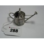 A Miniature Novelty Watering Can, allover detailed in relief, stamped "800".
