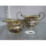 A Hallmarked Silver Jug and Matching Twin Handled Sugar Bowl, each of circular form with gadrooned