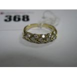 An 18ct Gold Band, of textured design with inset highlights.