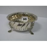 A Hallmarked Silver Dish, of shaped textured form raised on three cherub mask scroll pad feet,