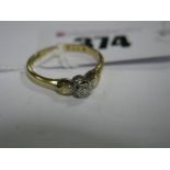 An Illusion Set Dress Ring, between textured shoulders, stamped "18ct Plat".