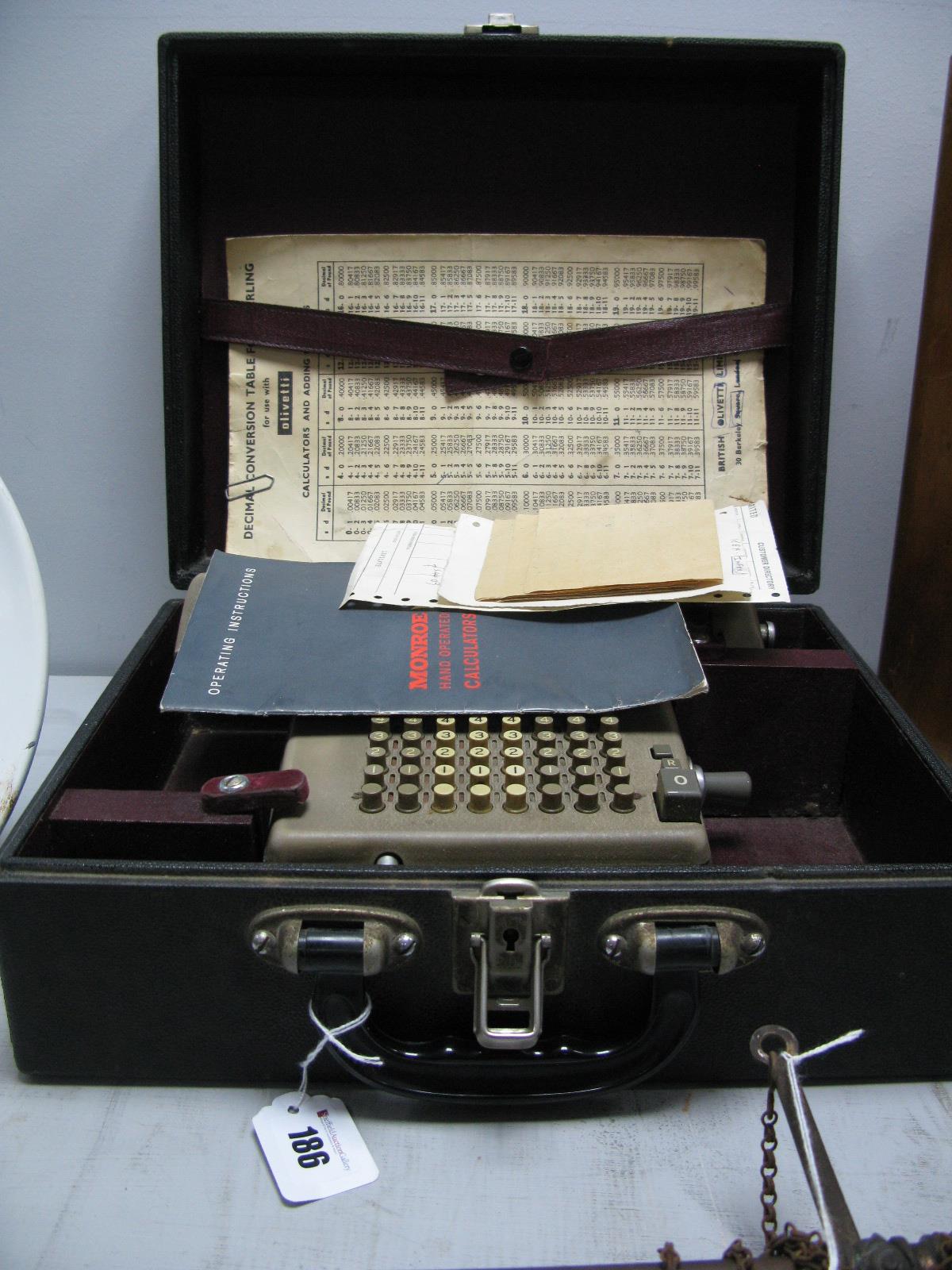 A Monroe Calculator, with key and instruction book.