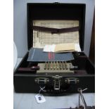A Monroe Calculator, with key and instruction book.
