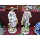 A Pair of XX Century Continental Figures, in classical dress, both carrying watering cans, 30cm