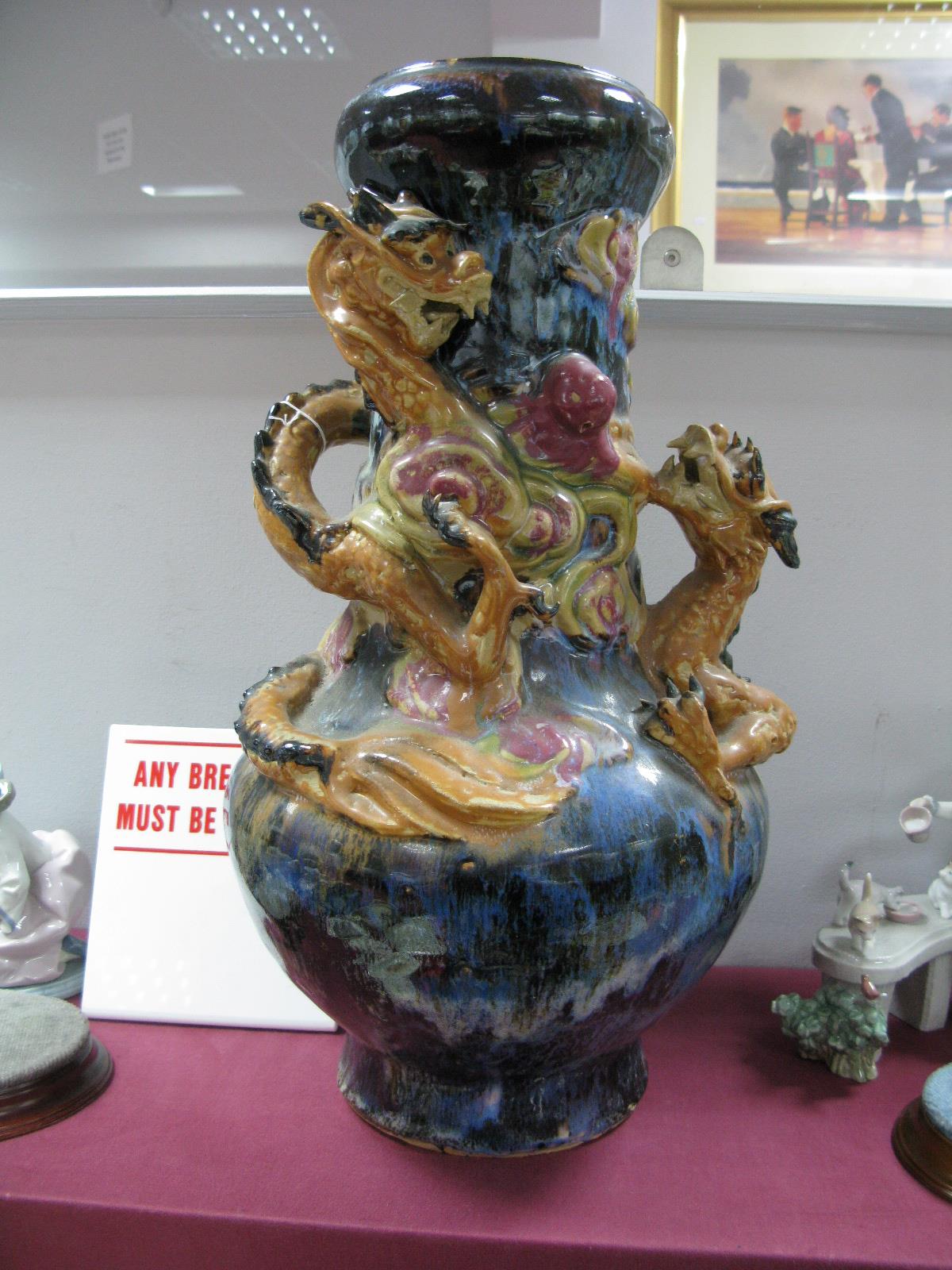 Oriental - Large pottery bulbous vase, featuring raised entwined serpent on mottled blue ground 50