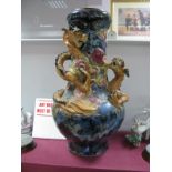 Oriental - Large pottery bulbous vase, featuring raised entwined serpent on mottled blue ground 50