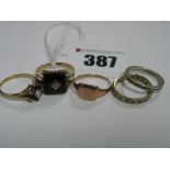 A 9ct Gold Gent's Panel Ring, two eternity bands, a signet style ring, etc.