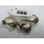 A 9ct Gold Cluster Style Dress Ring, claw set, between textured shoulders, a further two 9ct gold
