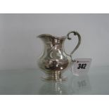 A Victorian Hallmarked Silver Jug, of plain baluster form, on circular spreading base, overall