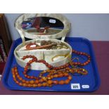 A Selection of Amber Coloured Bead Necklaces, other bead necklaces, amber coloured fountain pen, a