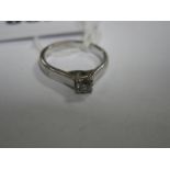 An 18ct Gold Single Stone Diamond Ring, the brilliant cut stone four claw set, between plain wide