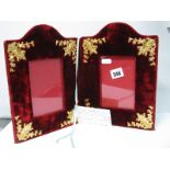 A Highly Decorative Dark Red Plush Double Aperture Photograph Frame, with applied gilt highlights,