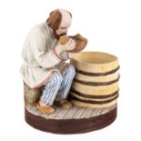 A RUSSIAN PORCELAIN FIGURE OF A MAN DRINKING, POPOV PORCELAIN FACTORY, CIRCA 1850S-1870S